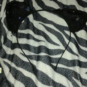 A black headband with sequins cat ears.