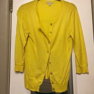 Bright yellow cardigan with faceted buttons