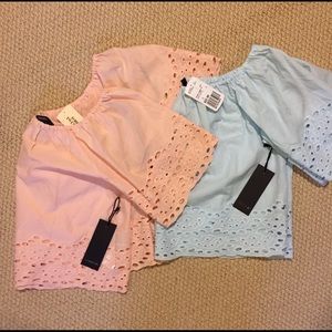 Lace eyelet crop top hits belly button or below