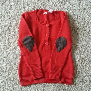 Red sweater with leaf elbow