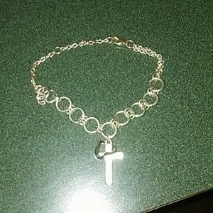 Cross with heart around iy