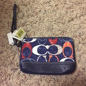 Navy blue Coach wristlet with tags still attached!