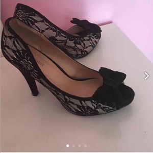 Nude and black lace pumps