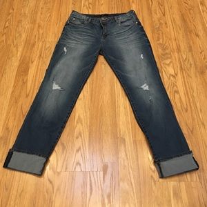 Distressed jeans with sewn cuffed bottom