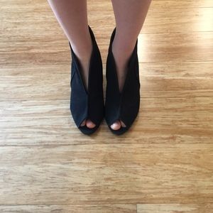 Front slit suede ankle bootie in black.