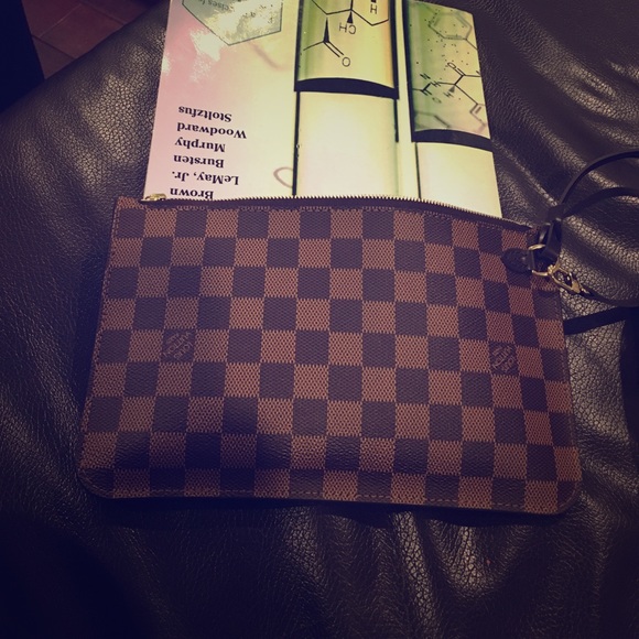 Louis Vuitton clutch with a wrist band