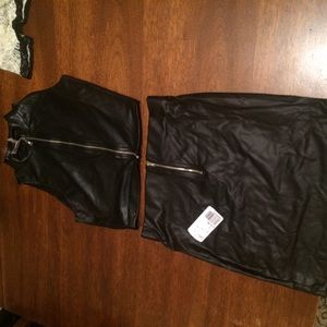 Black leather skirt and black crop top.