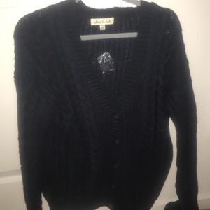 A navy blue button up cardigan by olive and oak