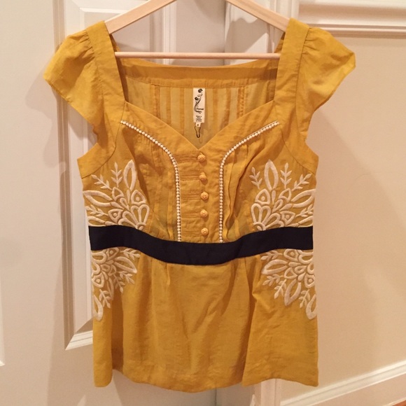 Yellow blouse with great detail.