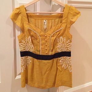 Yellow blouse with great detail.