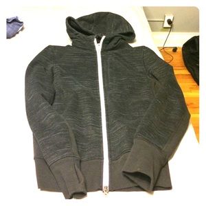 Black hooded zip-up Lululemon sweatshirt.