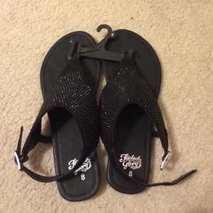 Black strapped sandals.