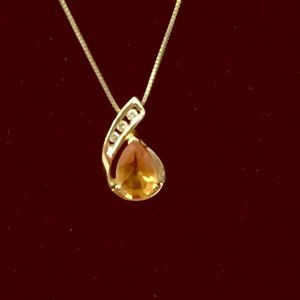 Topaz stone with 3 diamonds with a 14kt gold chain