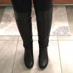 Knee high black boots with gold studs
