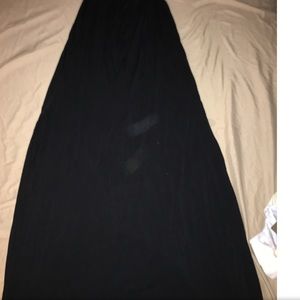 Long black dress with two slits at the side.