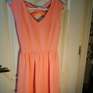 A sundress with a criss cross pattern on the back.