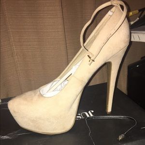 Platform cream heel w/ black straps.