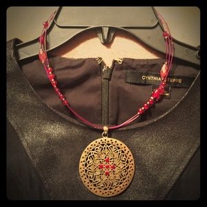 Medallion pendant necklace with red stones