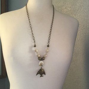 Long shell and brass fish pendant necklace