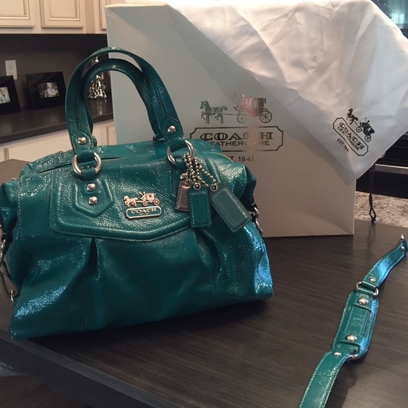 Coach purse in a shiny teal green.