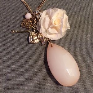 A beautiful 8 charm gold and lite pink Necklace 💕