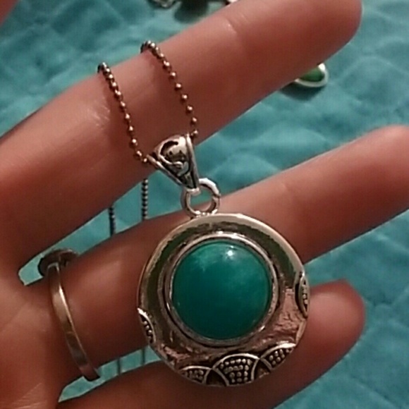 Faux turquoise stone in a circular silver setting