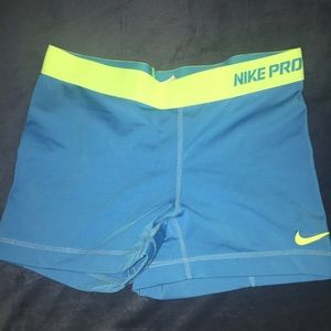 Blue and green Nike pros