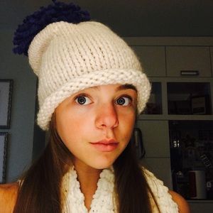 Hand Knit cream-colored hat with blue puff ball