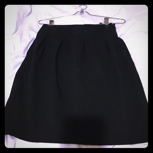 Black pleated front mini skirt