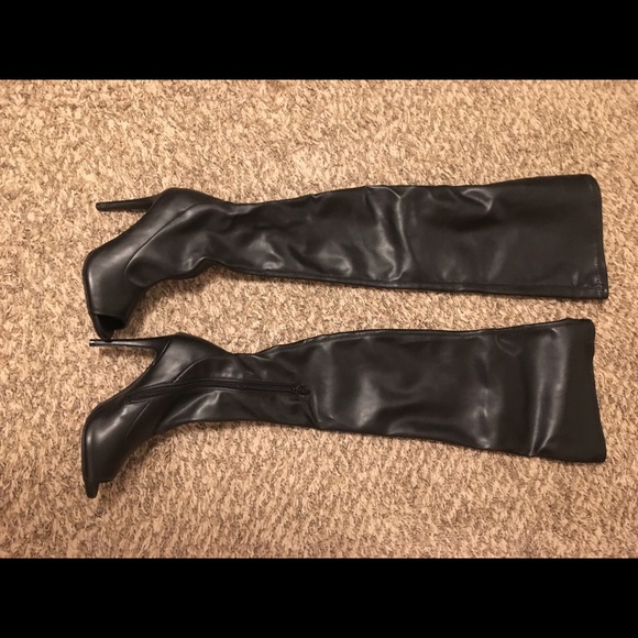 Thigh high leather open toe boots with heel.