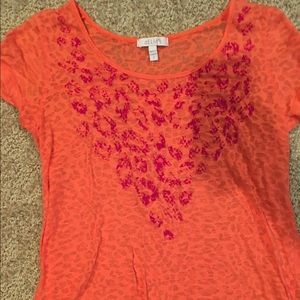 Delia's orange shirt