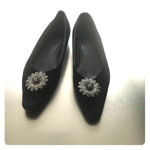 Black suede flats with embellishment on the front