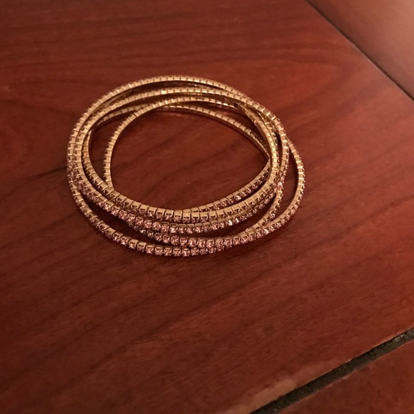 Stretchy gold bracelets with pink jewels