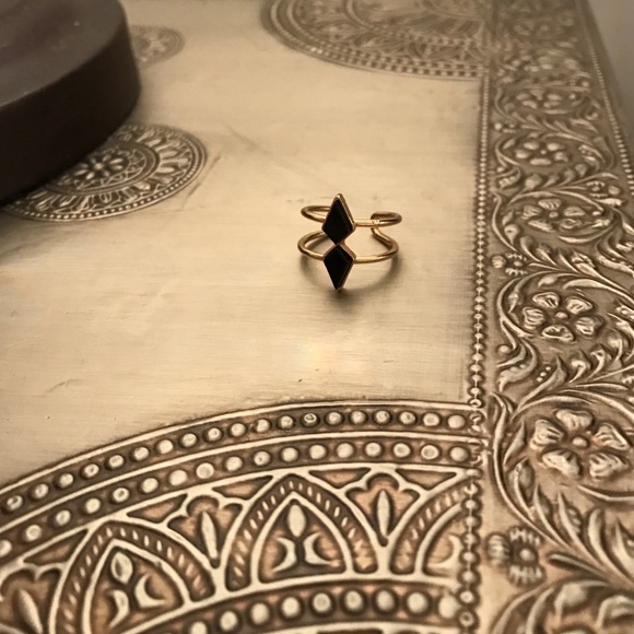 Gold ring with black stones