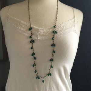 Long green beaded necklace with brass chain