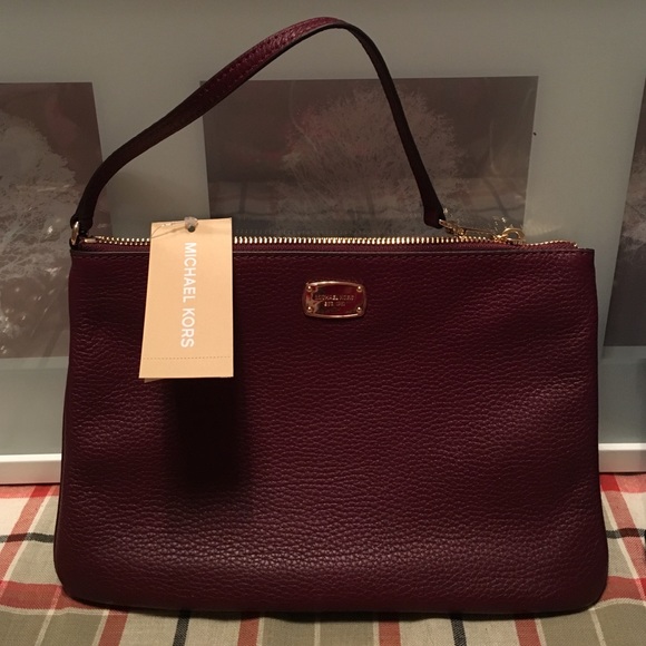 Michael Kors Handbags - Michael kors maroon clutch NWT