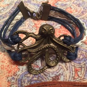 Set of three cord bracelets with charms