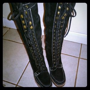 A pair of high knee lasted Michael kors boots