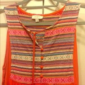 Orange knee length dress.