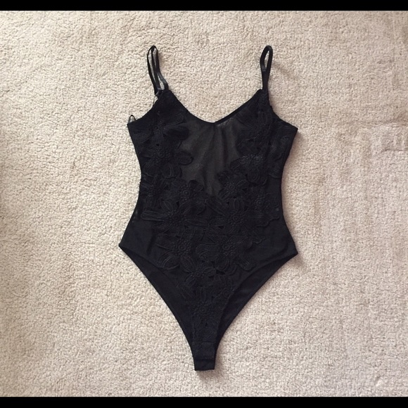 Black bodysuit with floral designs on it.
