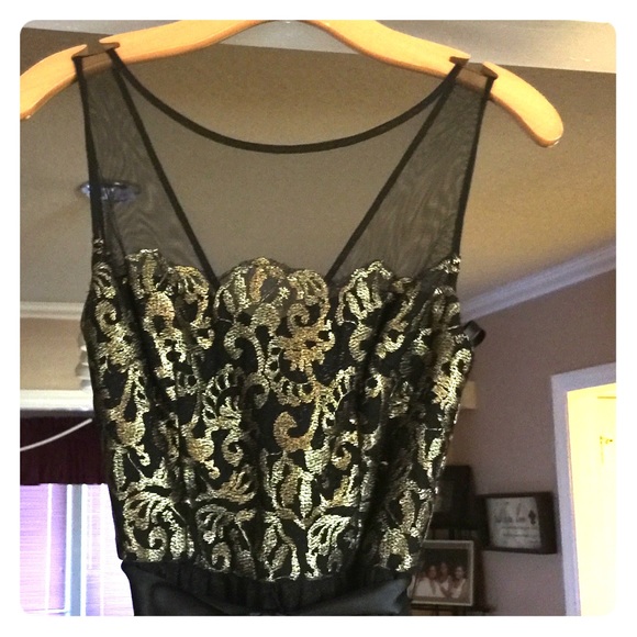 Caché gold and black gown.