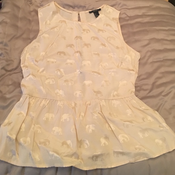 Peplum top with gold elephants.