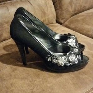 Black high heels with silver flower embellishment
