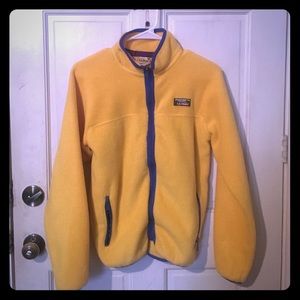 Yellow zip-up fleece. Blue zippers.