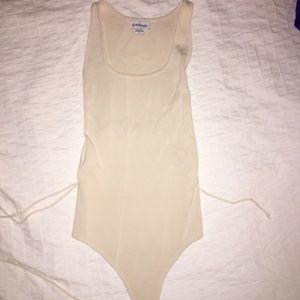 CREAM BEBE BODYSUIT NEVER WORN. TOO SMALL