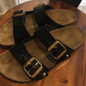 black patent birkenstocks with gold buckle