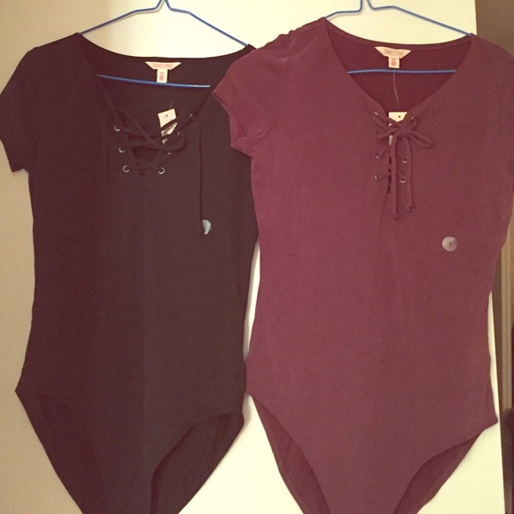 Two lace up body suits