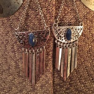 Silver dangle earrings with blue stone.
