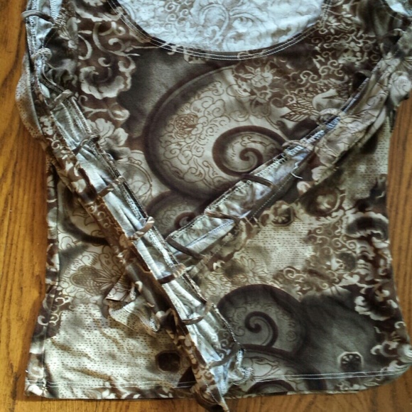 Blouse with shoulders and arms cut out.