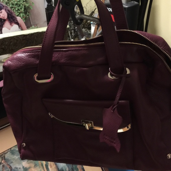 Genuine leather maroon colored handbag
